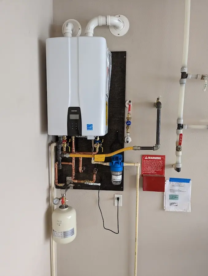 Professional plumber installing copper piping in a Stickney home